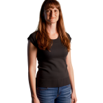 Lucinda Heyns wearing a black top and jeans, smiling.